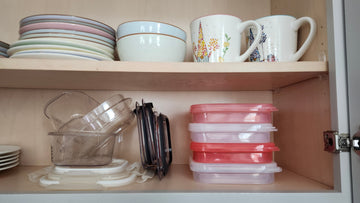 Collapsible food containers neatly stacked beside disorganized plastic food storage with separate lids.